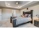 Bright main bedroom with a dark wood bed frame, neutral walls, and recessed lighting at 5392 Sanctuary Ave, Firestone, CO 80504