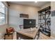 Well-lit home office with desk, shelving, and comfortable chair at 5392 Sanctuary Ave, Firestone, CO 80504
