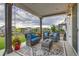 Covered patio features comfortable seating area and overlooks the green backyard at 5392 Sanctuary Ave, Firestone, CO 80504
