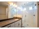 Elegant bathroom featuring a spacious glass shower with subway tile and bench, double sinks, and modern fixtures at 15858 E Broncos Pl, Englewood, CO 80112