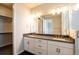 Modern bathroom with double sinks, white cabinets, granite countertops, and modern lighting at 15858 E Broncos Pl, Englewood, CO 80112