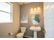 Stylish powder room featuring a pedestal sink, oval mirror, modern lighting and neutral wall color at 15858 E Broncos Pl, Englewood, CO 80112