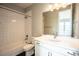 Bright bathroom featuring a bathtub with white subway tile surround and modern fixtures at 15858 E Broncos Pl, Englewood, CO 80112