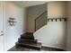 Inviting entryway features dark wood stairs, coat rack and decorative shelving for a modern aesthetic at 15858 E Broncos Pl, Englewood, CO 80112