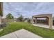 Wide backyard offering lush grass, wood fencing, a covered patio area, and an AC unit at 664 Stampede Dr, Brighton, CO 80603