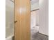 Small bathroom with a partial view of the shower/tub and a door looking out to a carpeted bedroom at 664 Stampede Dr, Brighton, CO 80603