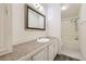Functional bathroom with a neutral countertop, a large mirror, and a shower/tub combo at 664 Stampede Dr, Brighton, CO 80603