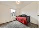 Comfortable bedroom with neutral carpet and a window overlooking the backyard, perfect for relaxation and rest at 664 Stampede Dr, Brighton, CO 80603
