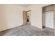 Bright bedroom with neutral carpet, an ensuite bathroom, and a closet for storage at 664 Stampede Dr, Brighton, CO 80603