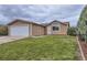 Charming single-story home featuring a well-maintained front yard and attached garage at 664 Stampede Dr, Brighton, CO 80603