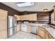Bright kitchen with light wood cabinets, stainless steel appliances, and ample counter space at 664 Stampede Dr, Brighton, CO 80603