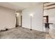 Spacious open-concept living room with neutral carpet and convenient access to other rooms at 664 Stampede Dr, Brighton, CO 80603