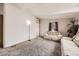 Cozy living room with neutral carpet, natural light, and comfortable seating area at 664 Stampede Dr, Brighton, CO 80603