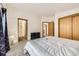 Spacious bedroom featuring neutral carpet, a large bed, and an ensuite bathroom for added convenience at 664 Stampede Dr, Brighton, CO 80603