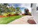 Spacious backyard featuring lush lawn, mature trees, a shed, and a concrete patio perfect for outdoor entertainment at 2160 Ance St, Strasburg, CO 80136