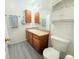 Well-lit bathroom with vanity, storage, and tile flooring at 2160 Ance St, Strasburg, CO 80136