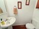 Powder bathroom featuring pedestal sink and decorative accents, adding style and convenience at 2160 Ance St, Strasburg, CO 80136