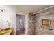 Accessible bathroom with shower, vanity, and towel rack at 2160 Ance St, Strasburg, CO 80136