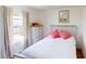 Cozy bedroom featuring neutral tones, a large window, and decorative accents at 2160 Ance St, Strasburg, CO 80136