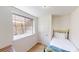 Small bedroom with a single bed, window, and carpeted floor at 2160 Ance St, Strasburg, CO 80136