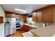Updated kitchen featuring stainless steel appliances, granite countertops, and ample cabinet space at 2160 Ance St, Strasburg, CO 80136