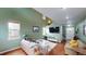 Inviting living room with beautiful hardwood floors, large windows, and comfortable seating arrangements at 2160 Ance St, Strasburg, CO 80136