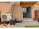 Back patio with AC unit, sliding glass door, and small step up to enter at 9105 Oberon Rd # 2, Arvada, CO 80004