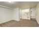 Basement area with new carpet and a utility sink at 9105 Oberon Rd # 2, Arvada, CO 80004