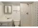 Bathroom with white and blue tiled shower, vanity, sink, and toilet at 9105 Oberon Rd # 2, Arvada, CO 80004