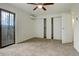 Neutral bedroom with a ceiling fan, updated mini-split system, and double closets at 9105 Oberon Rd # 2, Arvada, CO 80004