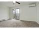 Bright bedroom with a ceiling fan, sliding glass doors and plush carpet flooring at 9105 Oberon Rd # 2, Arvada, CO 80004