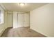 Bright bedroom features neutral carpet, white walls, and closet with sliding doors at 9105 Oberon Rd # 2, Arvada, CO 80004