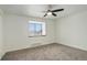 Bright bedroom with plush carpet flooring and a large window at 9105 Oberon Rd # 2, Arvada, CO 80004