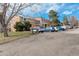 Row of two-story townhouses with car parking in front and landscaping at 9105 Oberon Rd # 2, Arvada, CO 80004