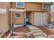 Charming home entrance with landscaped front yard and welcoming stairway at 9105 Oberon Rd # 2, Arvada, CO 80004
