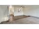 Open-concept living room showcasing carpet flooring, ceiling fan, and staircase at 9105 Oberon Rd # 2, Arvada, CO 80004