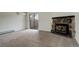 Spacious carpeted living room featuring a stone fireplace and sliding door access at 9105 Oberon Rd # 2, Arvada, CO 80004
