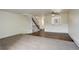 Bright living room with access to stairs, laminate and carpet flooring and natural light at 9105 Oberon Rd # 2, Arvada, CO 80004