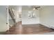 Open-concept living room featuring a ceiling fan, with view to kitchen and staircase at 9105 Oberon Rd # 2, Arvada, CO 80004