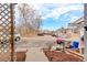 Street view of parking lot with cars, townhouses and landscaping visible at 9105 Oberon Rd # 2, Arvada, CO 80004