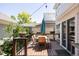 Outdoor dining area featuring a wood deck, table, and patio umbrella at 10069 E 28Th Ave, Denver, CO 80238