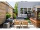 Backyard patio featuring comfortable seating, a fire pit, and lush landscaping at 10069 E 28Th Ave, Denver, CO 80238