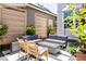 Backyard patio with outdoor seating, fire pit, and manicured landscaping at 10069 E 28Th Ave, Denver, CO 80238