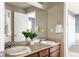 Bathroom featuring a dual sink vanity and large mirror at 10069 E 28Th Ave, Denver, CO 80238