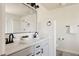 Bright bathroom featuring double sinks, a large mirror, and modern fixtures at 10069 E 28Th Ave, Denver, CO 80238