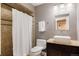 Bathroom featuring a shower, toilet, sink, and granite countertop at 10069 E 28Th Ave, Denver, CO 80238