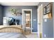 Bright bedroom with plant on shelf and doorway view to another room at 10069 E 28Th Ave, Denver, CO 80238