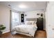 Cozy bedroom with a padded headboard and natural light at 10069 E 28Th Ave, Denver, CO 80238