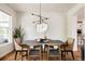 Elegant dining room featuring a modern light fixture, sleek table, and stylish decor for entertaining guests at 10069 E 28Th Ave, Denver, CO 80238