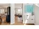 Bright entryway with hardwood floors, leading to a modern living room and stylish kitchen area at 10069 E 28Th Ave, Denver, CO 80238